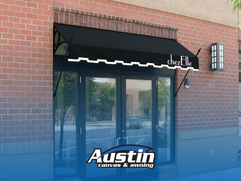 Elegant black fabric awning with valance, installed by Austin Canvas & Awning for a commercial entrance.