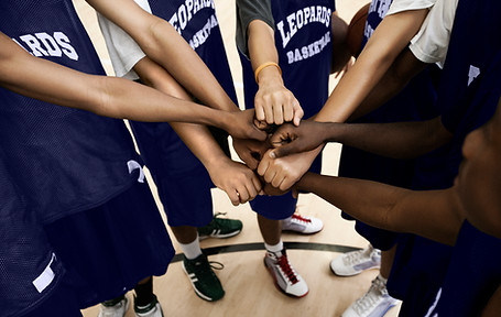 Team Putting Fists Together In Huddle