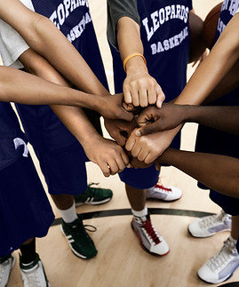 Team Putting Fists Together In Huddle
