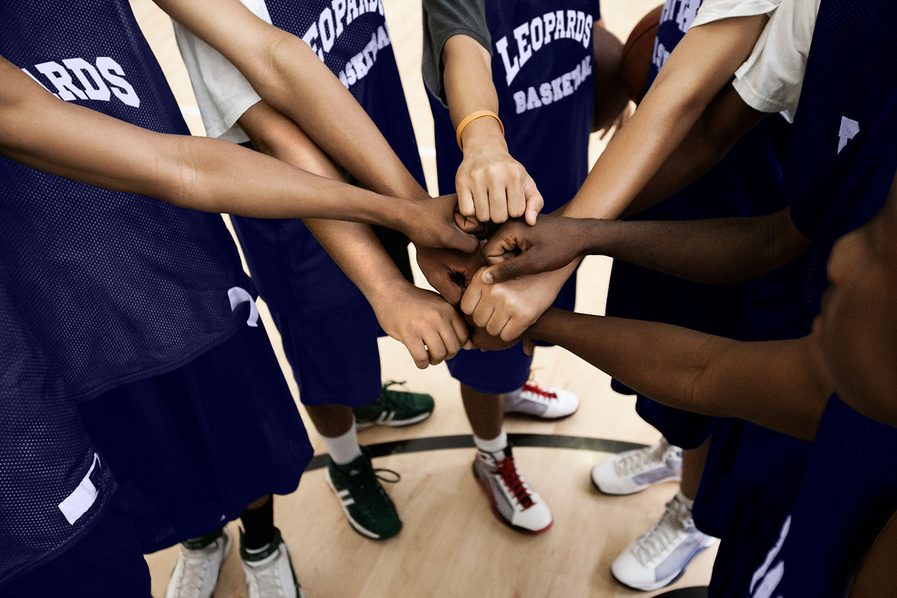 Team Putting Fists Together In Huddle