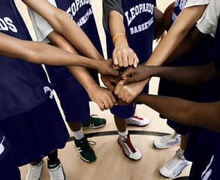 Team Putting Fists Together In Huddle