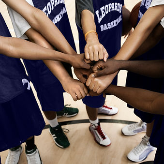 Team Putting Fists Together In Huddle