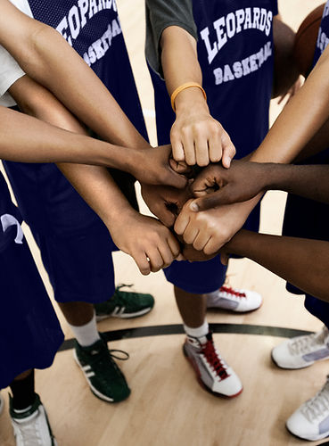 Team Putting Fists Together In Huddle