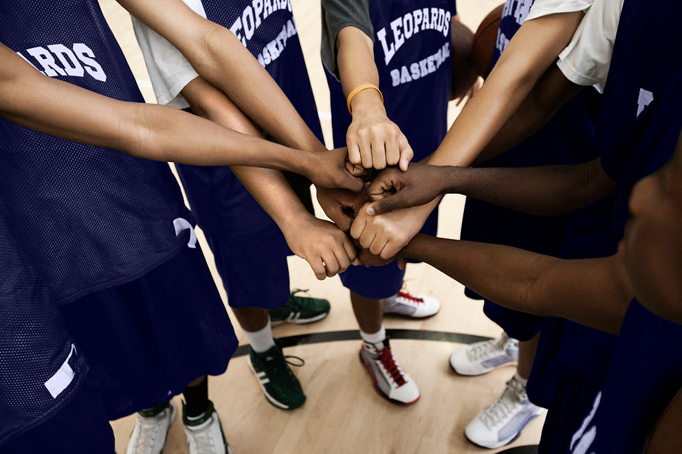 Team Putting Fists Together In Huddle