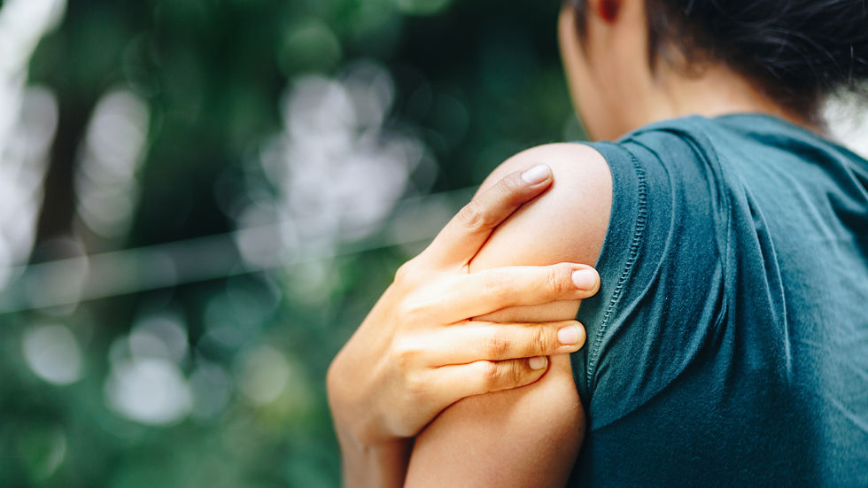 Person holding a painful shoulder, a common symptom of rotator cuff injuries and nighttime shoulder pain treated with physiotherapy in Edmonton.