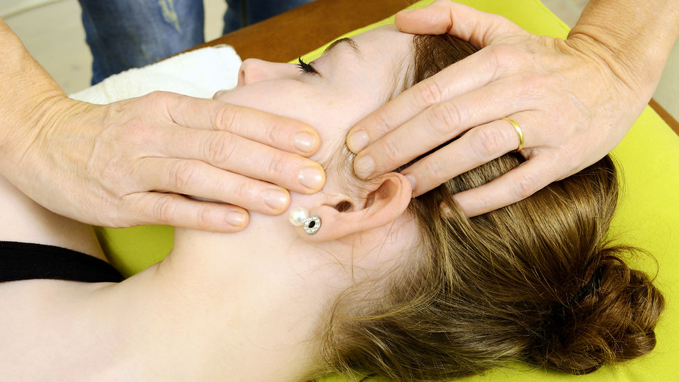 Physiotherapist providing hands on jaw treatment during TMJ Physiotherapy Edmonton session
