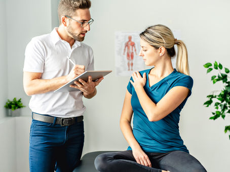 A physiotherapist guiding a client through a movement assessment during a private session in Edmonton.