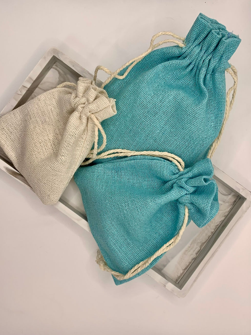 Thumbnail: Fabric pouches of various colours, blue, and off white pouch. 