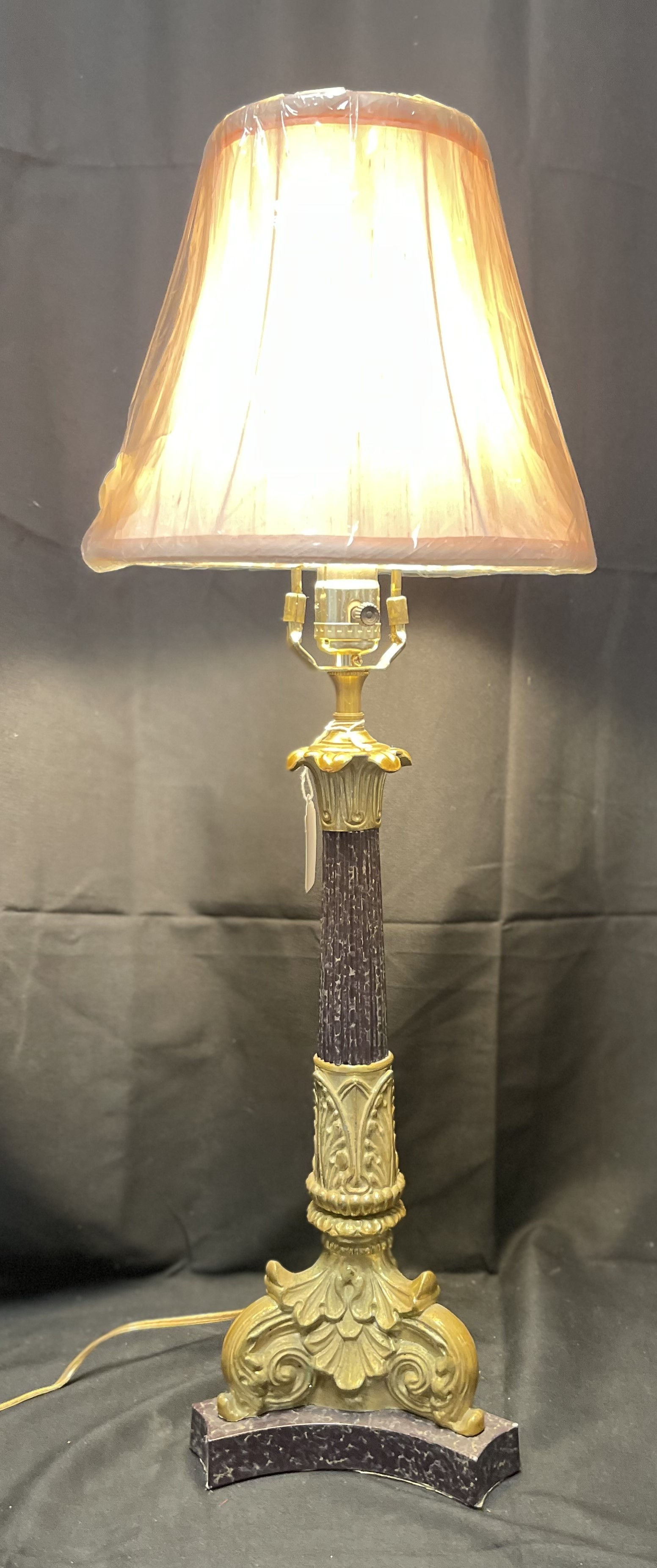 Ornate gilded column table lamp with textured column.