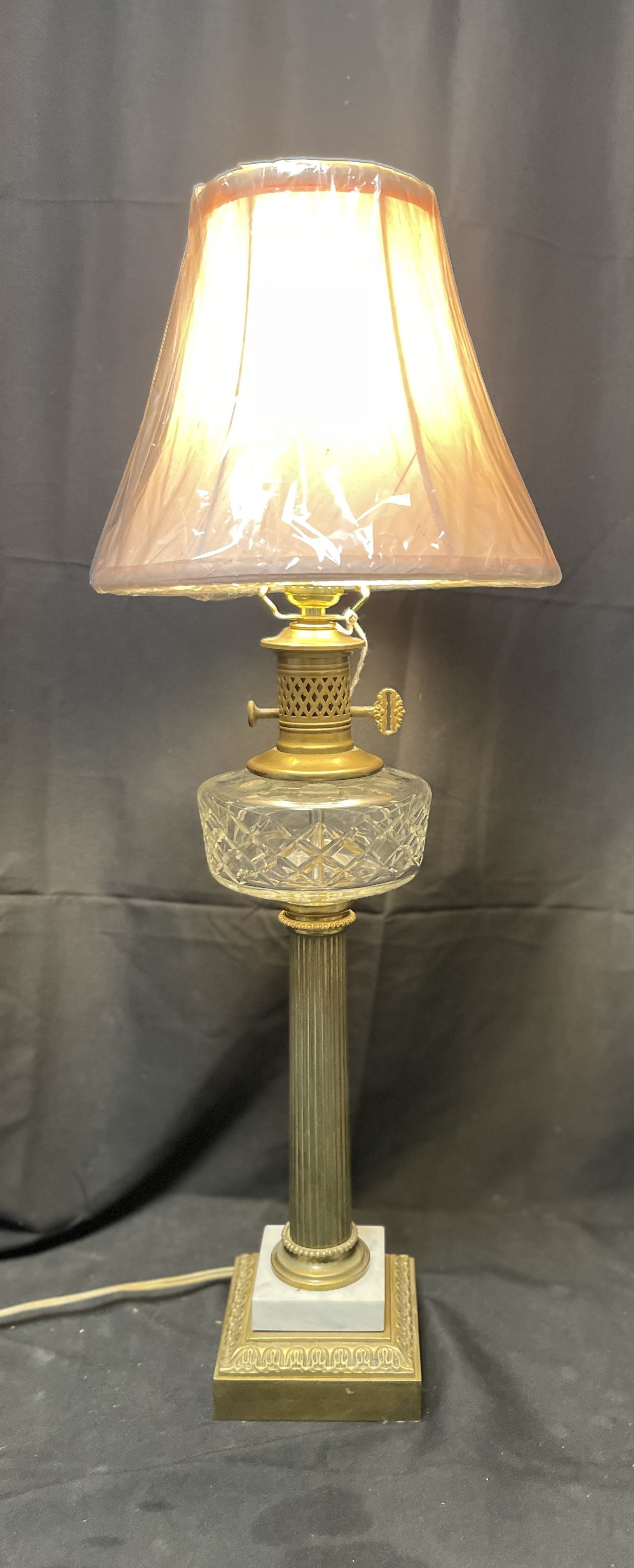 Converted brass and crystal oil lamp with a fluted column.