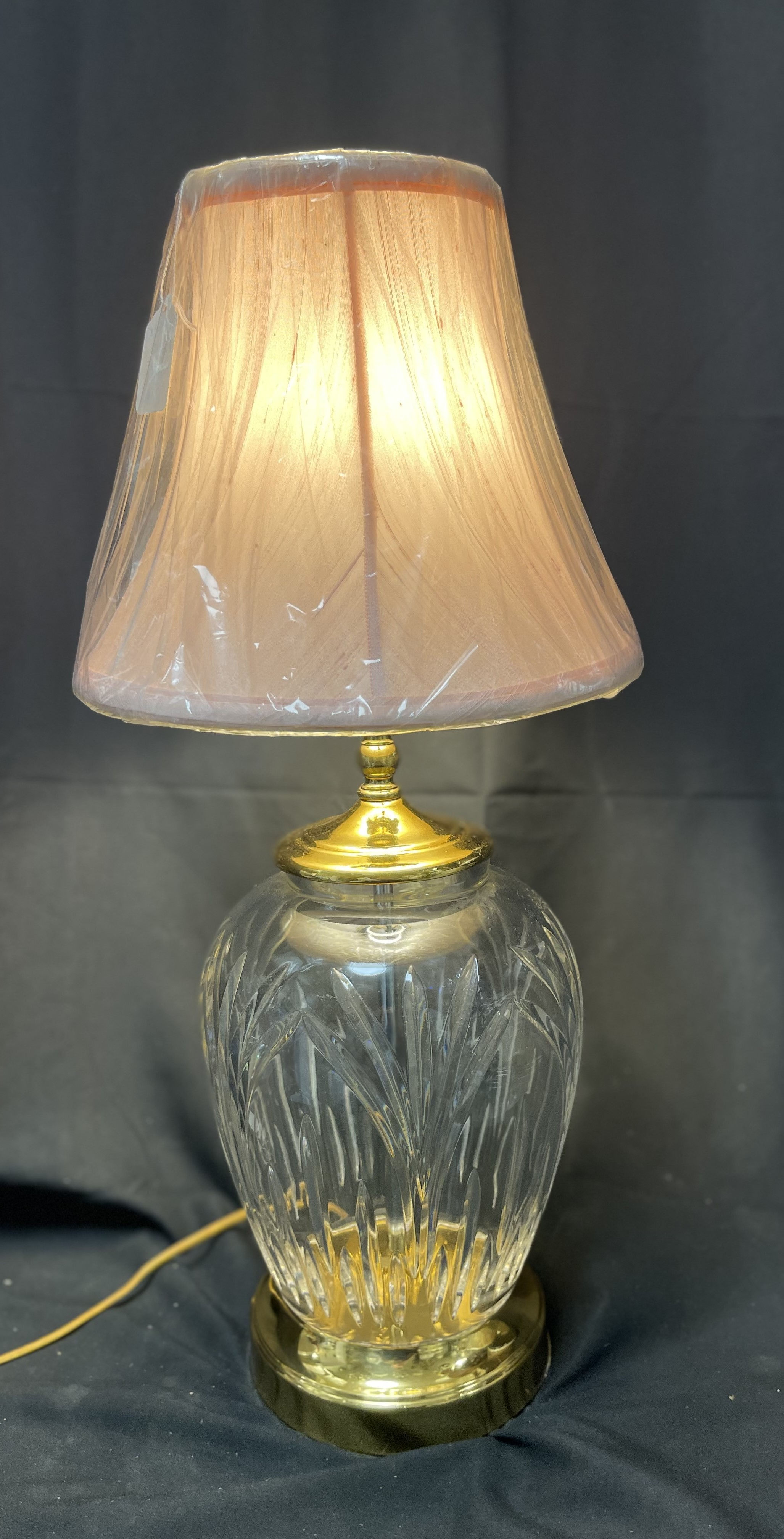 Vintage cut crystal and brass table lamp with urn-shaped body.