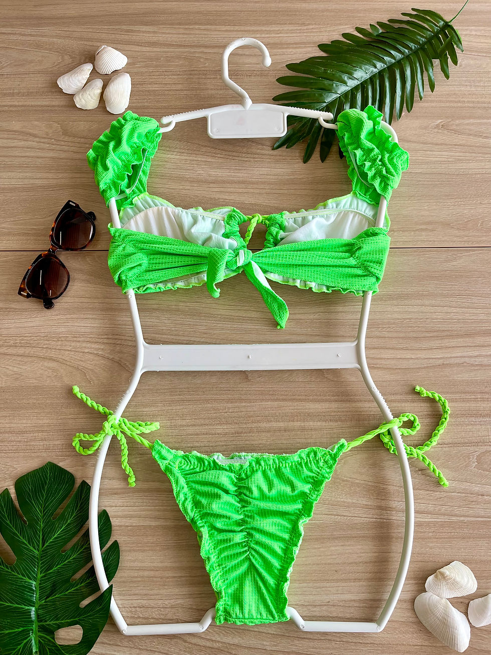 Thumbnail: Green Bandeau bikini with short sleeves and tie-side bikini bottom in a vibrant floral pattern, displayed on a flat surface.