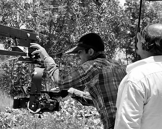 Hashem Karimi filming in the past, symbolizing the founding journey of Human Lens Media CIC