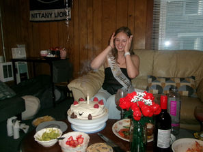 Young woman placing birthday candles on a pastel-decorated Jellycat-inspired cake.
