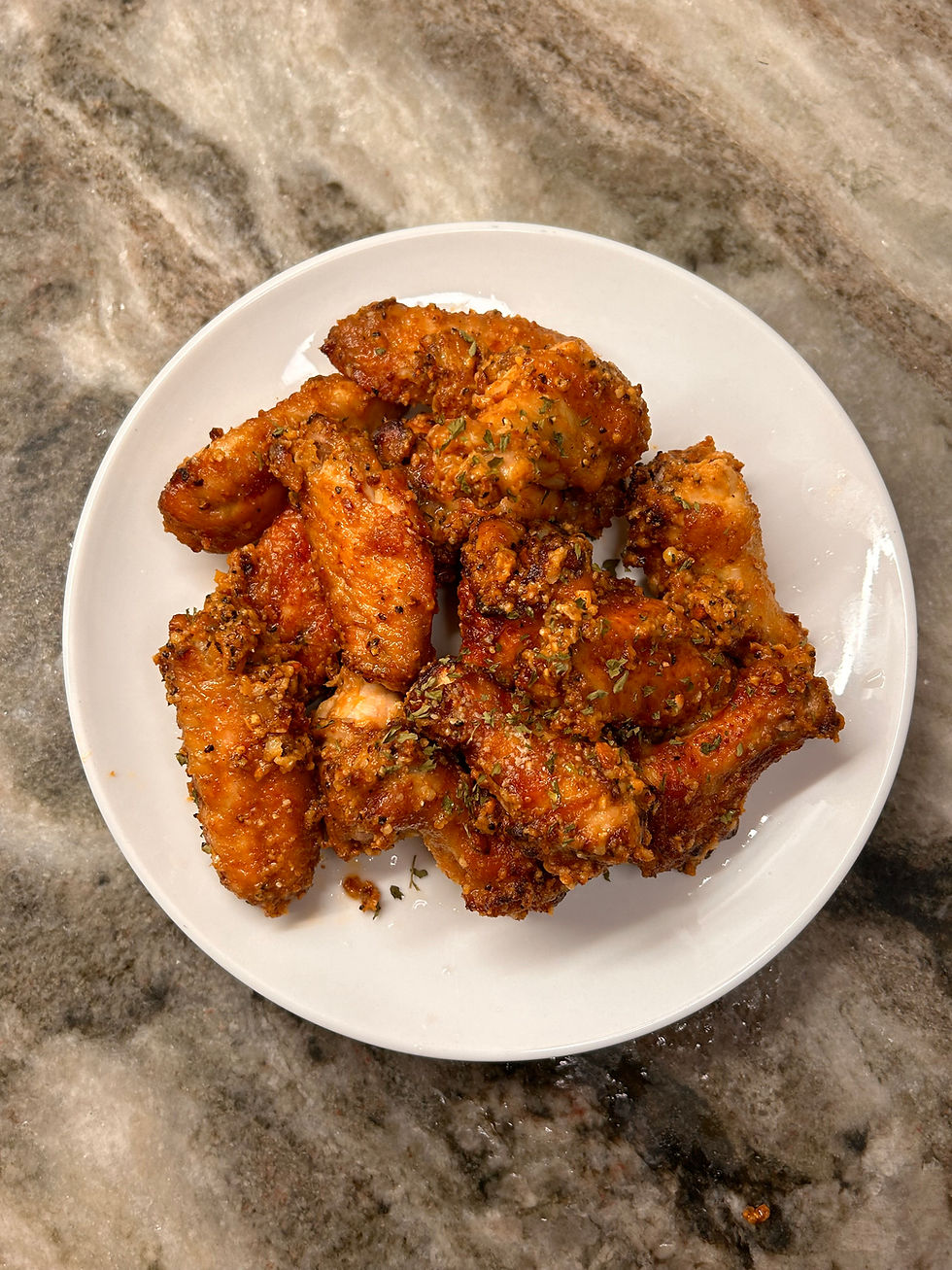 Baked Lemon Pepper Garlic Parmesan Wings on a white plate homemade
