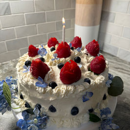 Strawberry, Blueberry, Vanilla Chantilly Cake with hydrangea flowers and whipped cream frosting 