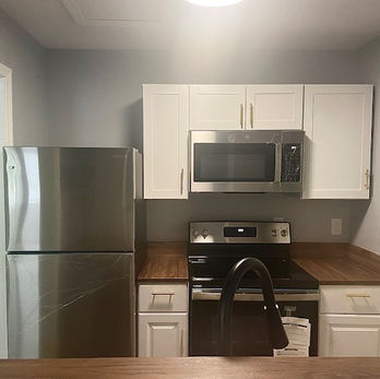 New kitchen with new appliances, butcher block counters stained dark walnut