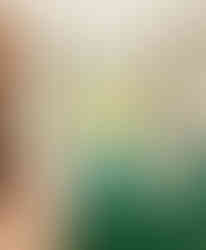 finished bedroom with green bedspread and view to outside