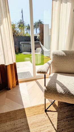 textured beige modern lounge chair with view out of the window