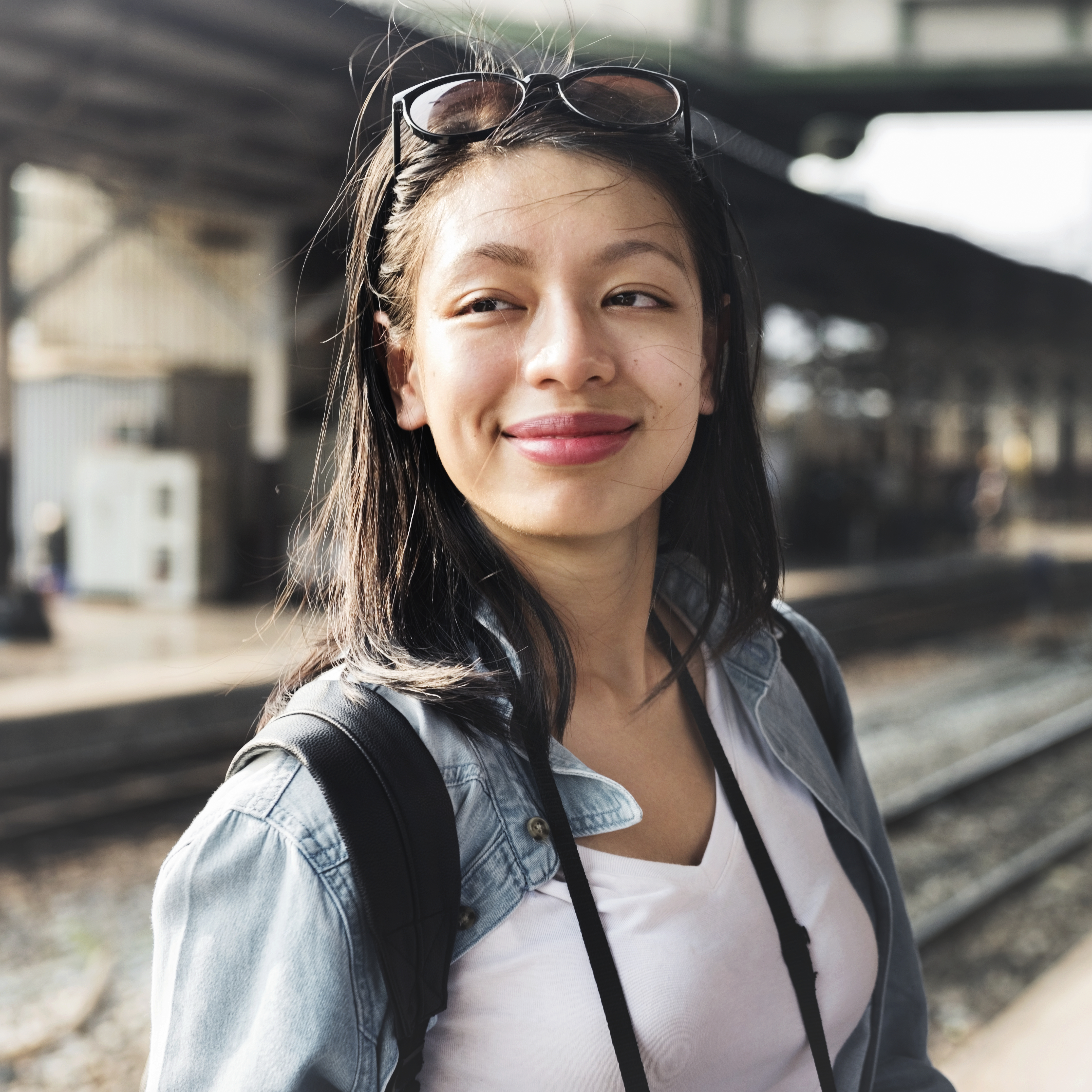 woman-traveler-smiling-at-train-station-platform-2026-03-18-11-11-54-utc.jpg