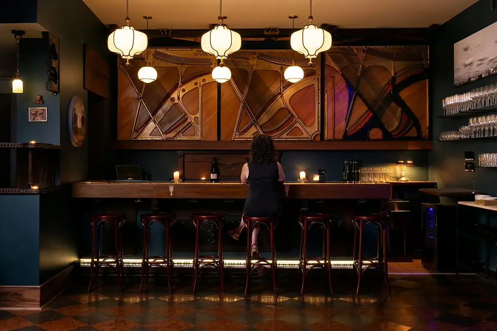 Woman sitting at the bar of Augusta on-premises