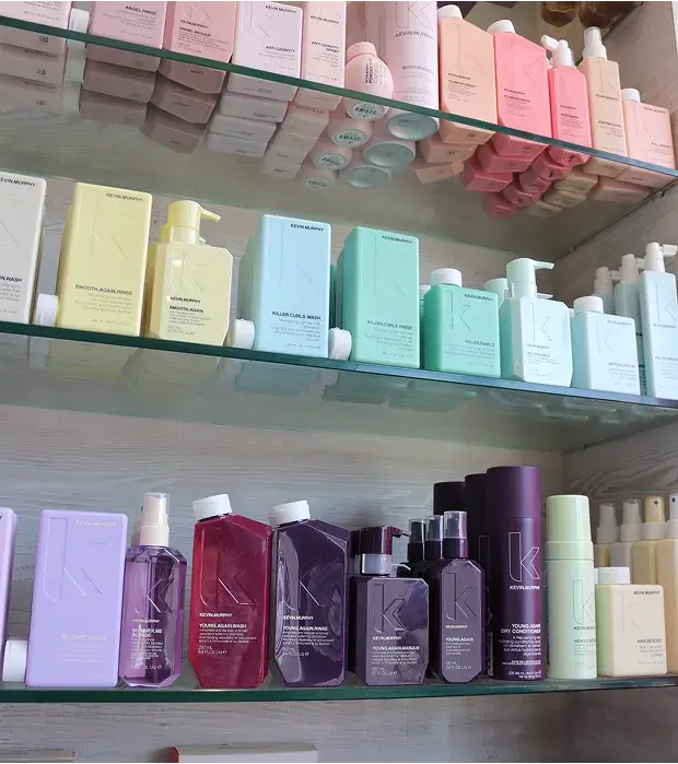 Pastel hair products on shelves at Cats Whiskers Hair Salon