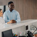 Healthcare front desk staff verifying patient insurance and registration details to prevent claim denials and improve revenue cycle performance