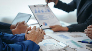 Business owner reviewing bookkeeping reports, cash flow statements, and financial records to identify gaps that impact business growth