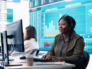 Customer service and data analytics professionals working in a modern office with digital dashboards — showcasing global data monitoring, technical support, and real-time business intelligence.