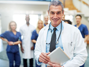 Healthcare administrator starting provider credentialing process with payer enrollment documents and onboarding checklist for a new physician hire