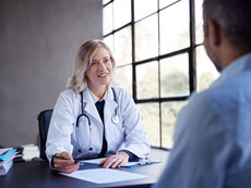 Healthcare credentialing specialist reviewing CAQH provider profile information to prevent enrollment delays and reimbursement issues