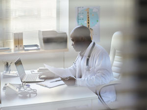 Healthcare administrator reviewing provider enrollment applications and payer approvals while monitoring revenue and onboarding timelines