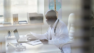 Healthcare administrator reviewing provider enrollment applications and payer approvals while monitoring revenue and onboarding timelines