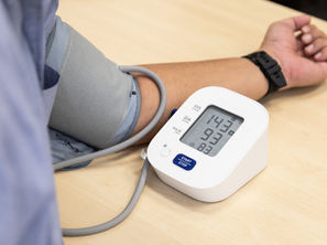Adult discussing blood pressure cholesterol and blood sugar measurements during a preventive health evaluation