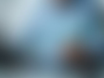 Professional reviewing financial charts on a laptop with stylus, overlaid with digital candlestick graphs and percentages — symbolizing investment analysis, market performance, and data-driven decision-making.