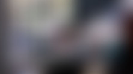 Healthcare team interacting with patients in a modern clinic waiting area — highlighting compassionate care, accessibility, and multi-generational patient engagement.