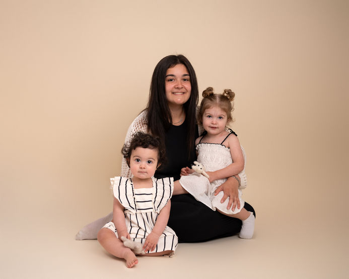 Mother sitting with her children during a natural family photography session