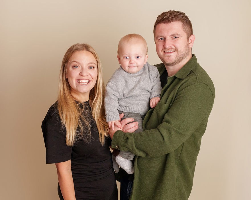 Parents holding their baby during a relaxed family photography session in Derbyshire
