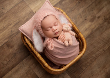 Sleeping newborn baby photographed in a basket during a Derbyshire studio session