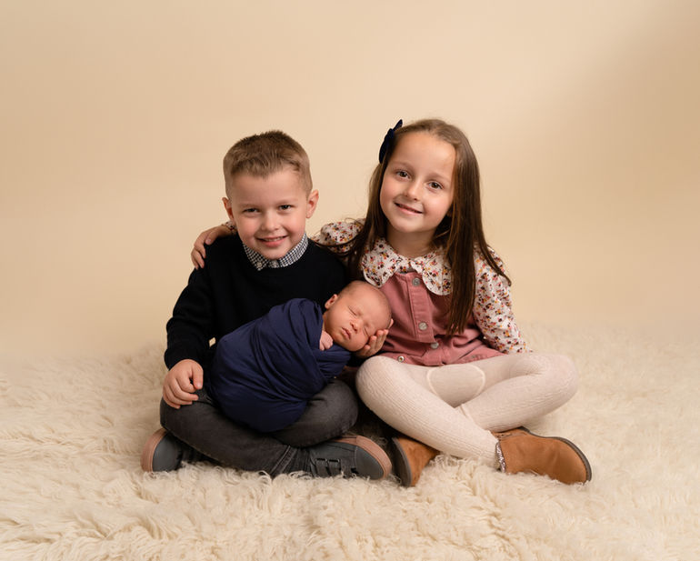 Brother and sister sitting together during a relaxed family photoshoot in Derbyshire