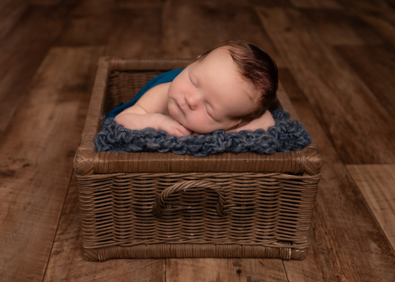Newborn baby boy photographed in a wooden crate in Swanwick, Derbyshire
