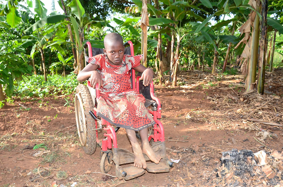 Child with disability in a wheelchair in rural Uganda, showing the importance of CHOCU’s shoe and mobility support programs.