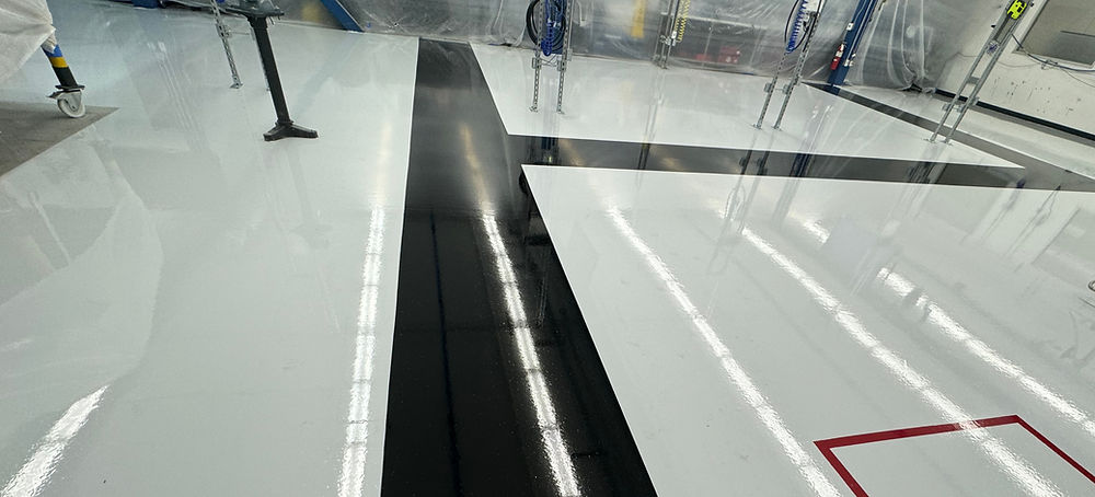 Shiny white and black industrial epoxy flooring