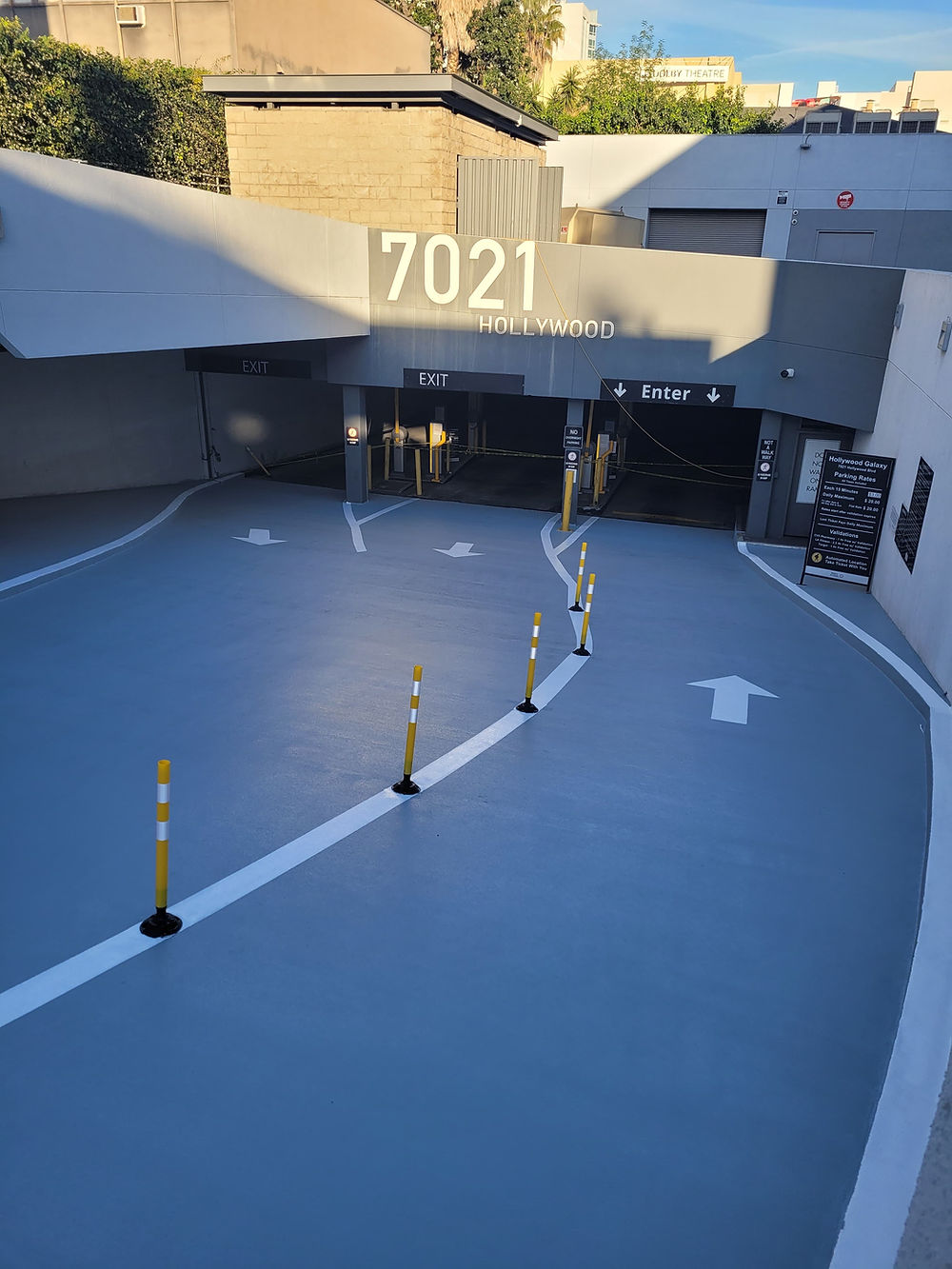 Building 7021 entrance with paved drive and yellow bollards