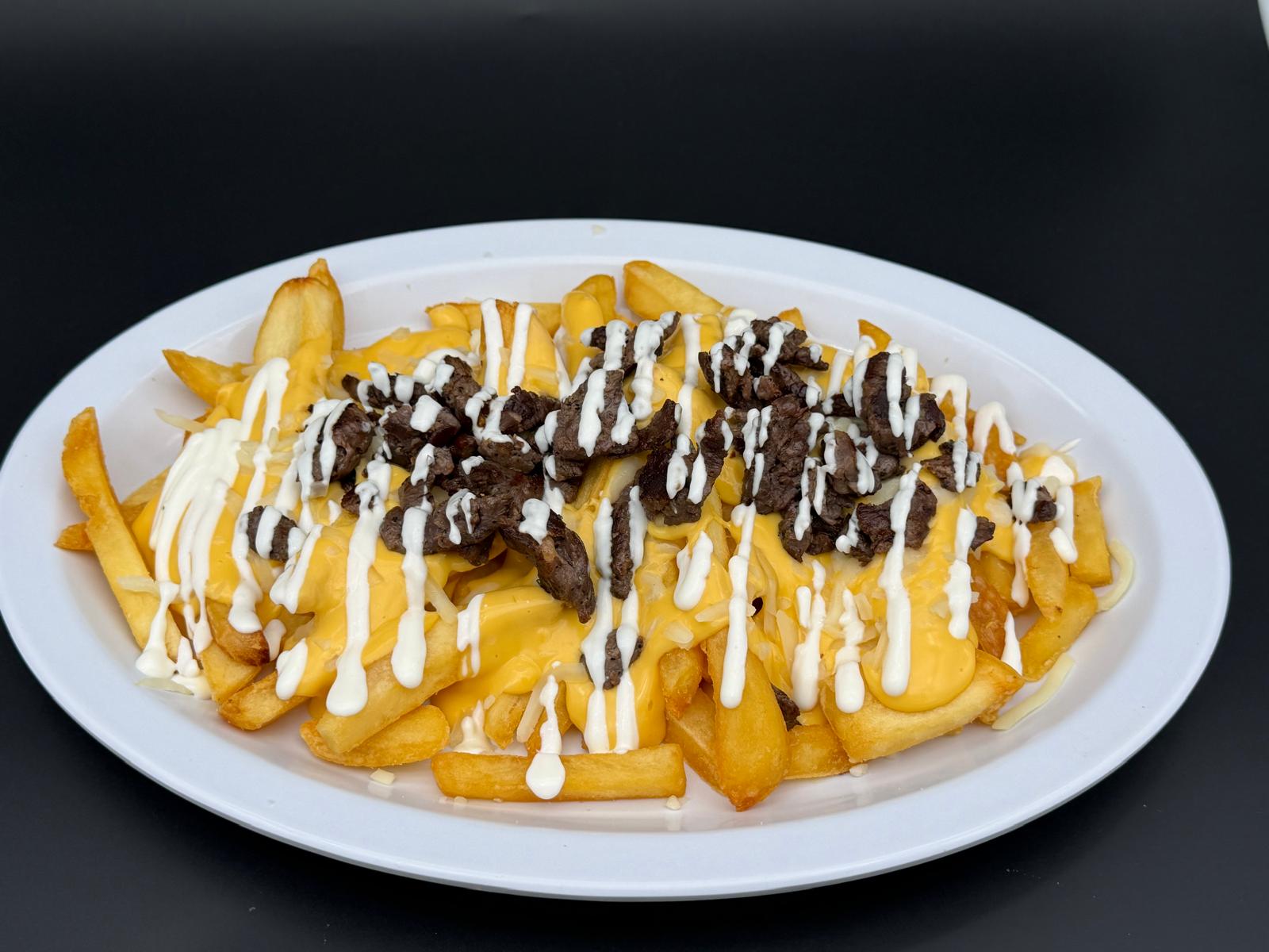 Carne Asada Fries with yellow cheese, Monterey cheese and sour cream