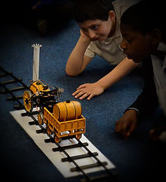 boys using a steam train in our key stage 1 and 2 victorians primary school workshop