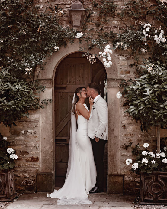 Wedding couple sharing a romantic moment outside at Middleton Lodge, Yorkshire, captured in an elegant and timeless style