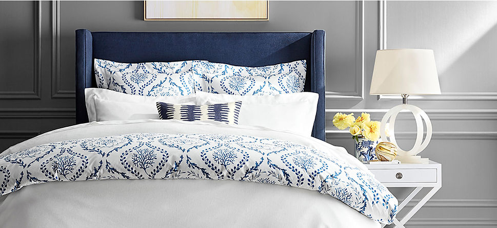 Bedroom with upholstered bed, nightstand. Blue and white