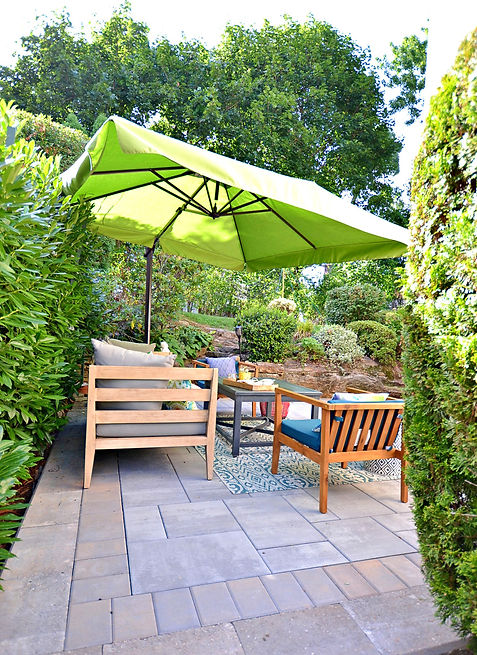 Patio with expansive umbrella and furniture