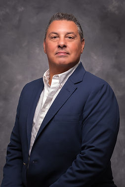 Richard Aquilone, Jr., in blue blazer, professional headshot.